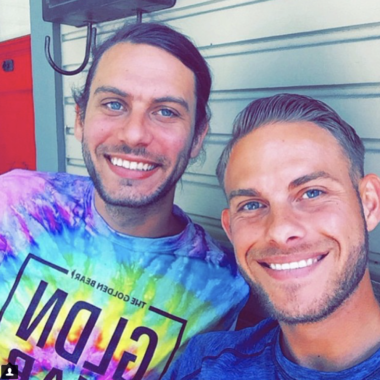 Two men smiling